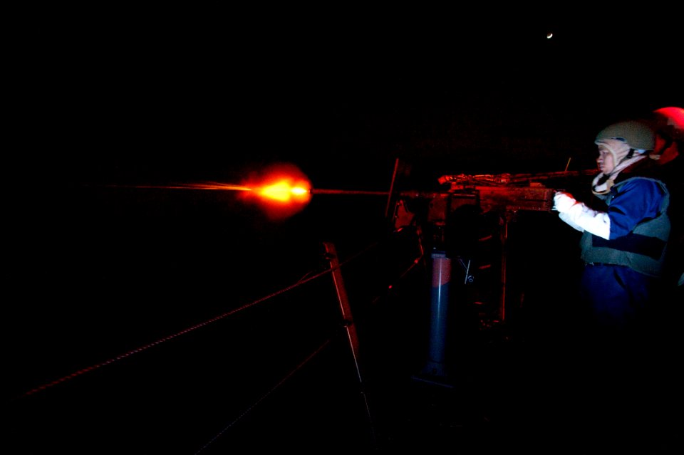 US Navy 100614-N-5319A-116 viation Boatswain's Mate 3rd Class Delany Bantol fires from a .50-caliber gun mount