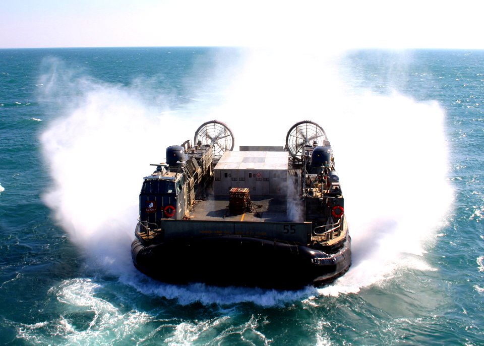 US Navy 081119-N-5681S-040 A landing craft air cushion maneuvers towards the multi-purpose amphibious assault ship USS Iwo Jima (LHD 7)