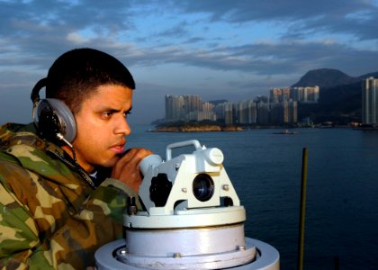 US Navy 081122-N-9520G-004 Quartermaster Seaman Elvis Gomez, from Manhattan, N.Y., and assigned to the forward-deployed amphibious assault ship USS Essex (LHD 2), makes reports on surface contacts as Essex enters Hong Kong harb photo