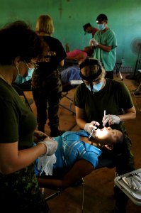 US Navy 081119-N-8907D-022 Military dentists and dental technicians embarked aboard the amphibious assault ship USS Kearsarge (LHD 3) perform dental procedures during medical operations at the Port Kaituma Skills Training Centr