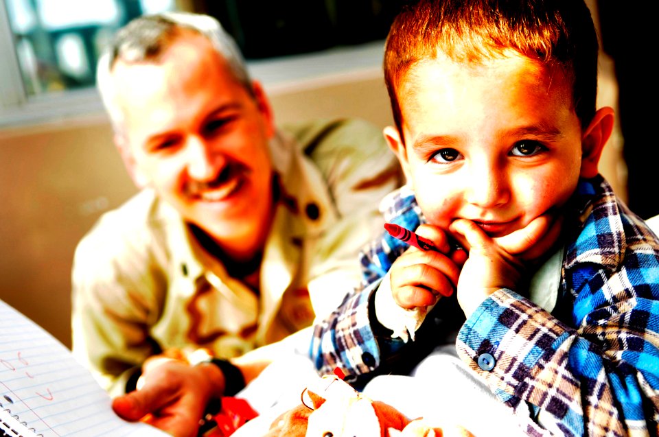 US Navy 081120-N-6651N-031 U.S. Navy Cdr. Gregory Harris colors with an Afghan boy in the Indira Gandhi Children's Hospital Burn Ward