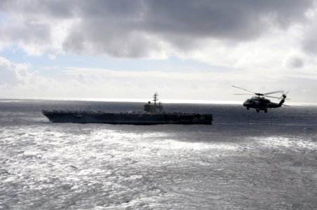 US Navy 081120-N-3659B-124 An HH-60H Sea Hawk flies past the Nimitz-class aircraft carrier USS Ronald Reagan (CVN 76)