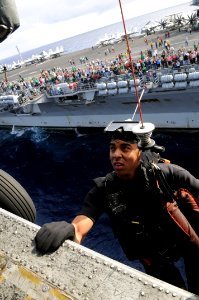 US Navy 081120-N-3659B-153 Naval Aircrewman Airman Jeffrey Edwards is hoisted back into an SH-60F Sea Hawk assigned to HS-4 alongside USS Ronald Reagan (CVN 76) during practice for an air power demonstration