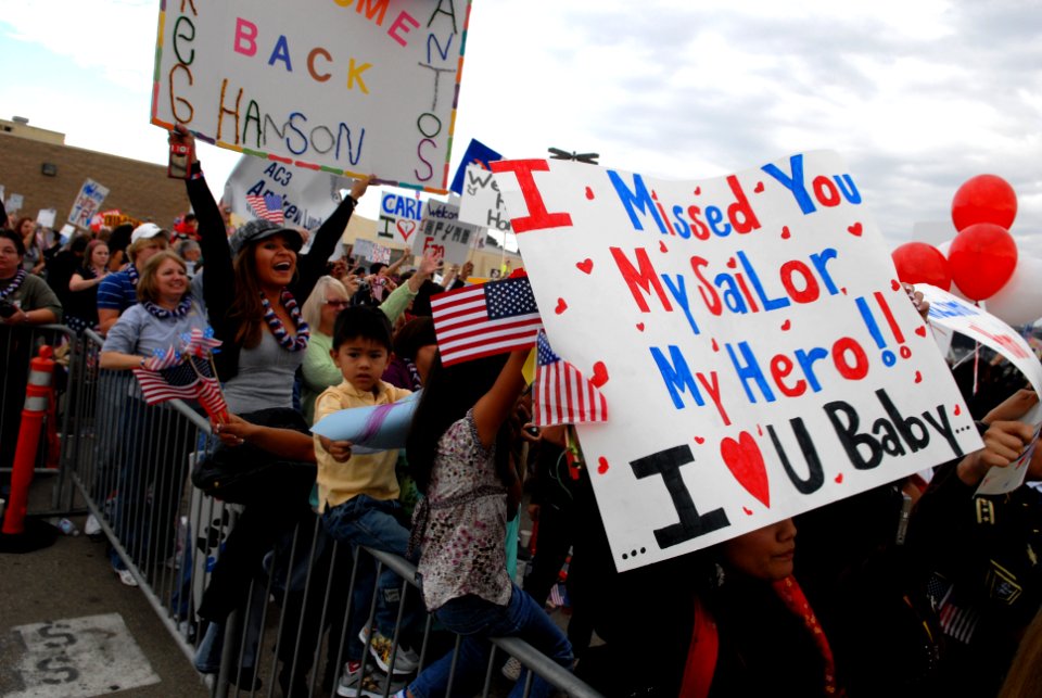 US Navy 081125-N-1635S-001 Friends and family members of Sailors aboard the Nimitz-class aircraft carrier USS Ronald Reagan (CVN 76) celebrate as the ship completes its transit into Naval Air Station North Island