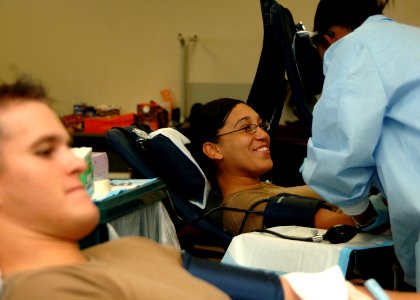 US Navy 081122-N-8816D-160 EACA Joseph Turner, foreground, and YNSA Crystal Morales, both assigned to NMCB-133, are monitored by HM3 Calvanna Major, assigned to U.S. Pacific Command's Armed Services Blood Bank Center, during a
