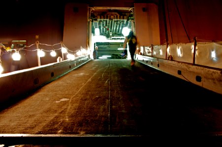 US Navy 101118-N-9643K-869 Operations Specialist Seaman Michael Pa stands watch as a shipyard worker walks up the ramp to the quarterdeck aboard th