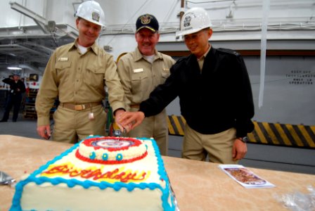 US Navy 081126-N-8772M-063 Lt. Cmdr. Dean Hoelz, Capt. Daniel H. Fillion, and Chaplain Fulgencio Legaspi cut a ceremonial cake honoring the 233rd birthday of the U.S. Navy Chaplain Corps