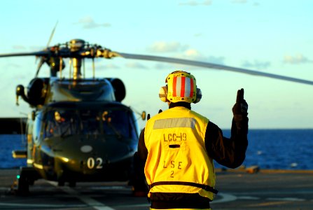 US Navy 081120-N-2013O-114 Boatswain's Mate 3rd Class Leland Harris, from Birmingham, Ala., signals the pilot of an SH-60B Sea Hawk from Helicopter Anti-Submarine Squadron Light 51