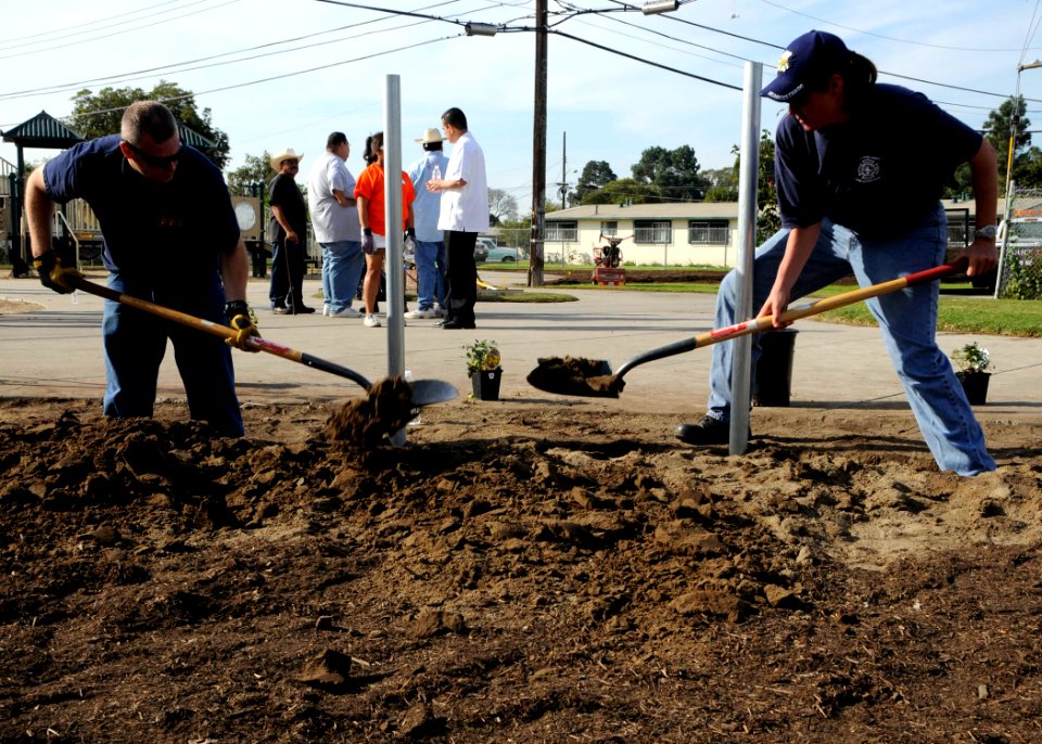 US Navy 081122-N-9584N-002 Chief Steel Worker Allen Egelston and Senior Chief Utilitiesman Jamie Rainwater work together to dig a ditch during a community relations project
