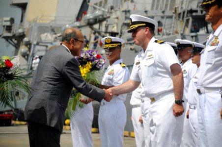 US Navy 100723-N-3283P-054 Cmdr. Rodney Patton reets a member of the Japan-America Society during a welcome ceremony at Takamatsu Pier