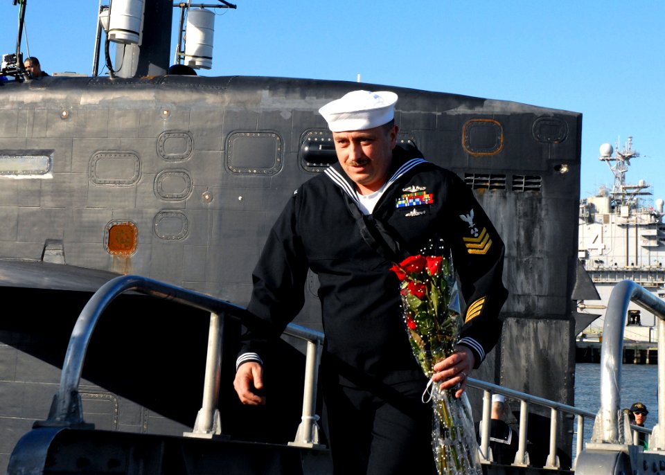 US Navy 081124-N-7668G-068 Machinist's Mate 1st Class Michael Jonet goes ashore with flowers for his wife
