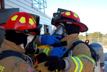 US Navy 081126-N-3289C-046 Aviation Boatswain's Mate Handler 2nd Class Ryan Hernandez checks Aviation Boatswain's Mate Handler 2nd Class Keith Deskin's firefighting gear