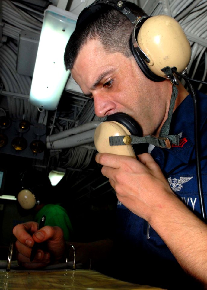 US Navy 081130-N-2456S-073 Aviation Boatswain's Mate (Equipment) 1st Class Tony Pavao ensures all personnel are manned on station