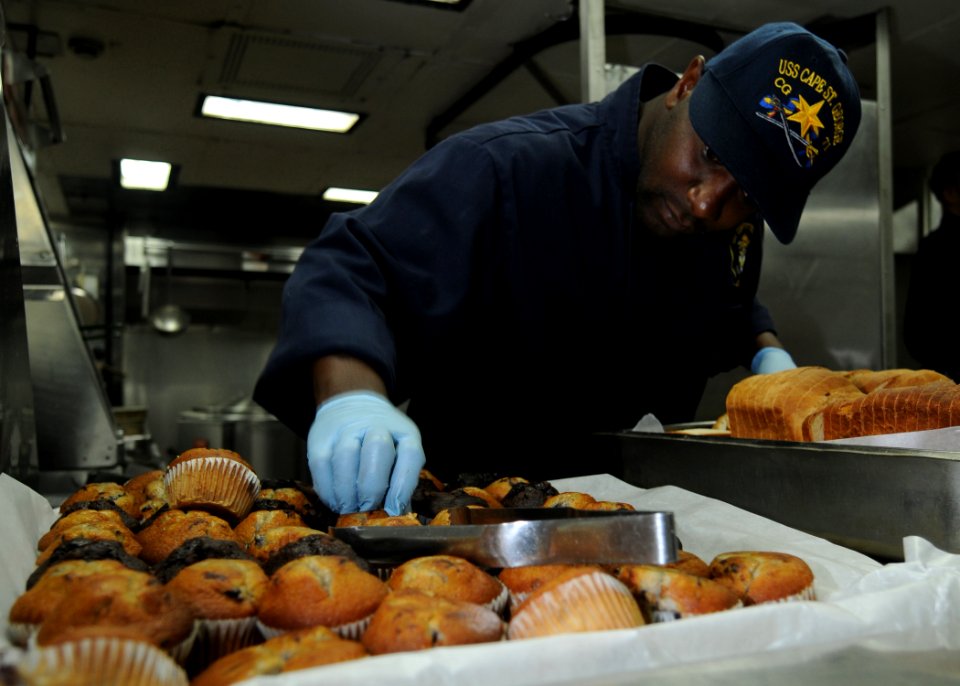 US Navy 101018-N-5016P-011 Culinary Specialist 3rd Class Tony Parker prepares breakfast aboard the guided-missile cruiser USS Cape St. George (CG 7