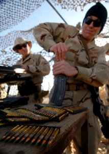 US Navy 081127-N-6278K-045 Lt. j.g. Shauna Egan, assigned to Explosive Ordnance Disposal Mobile Unit (EODMU) 1, loads a magazine for her M-4 rifle on the range at Contingency Operating Base Speicher, Iraq