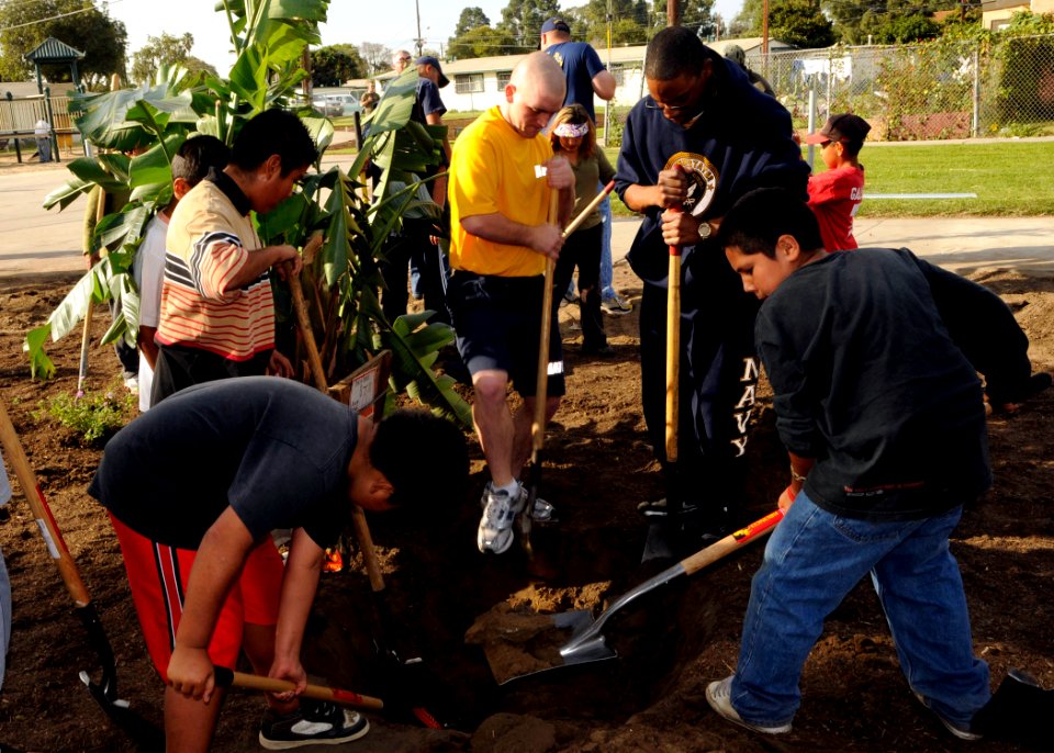 US Navy 081122-N-9584N-001 Construction Mechanic Constructionman Recruit Gerrett Meyer and Construction Mechanic Constructionman Recruit Scotty Williams work with students from Cesar Chavez Middle School during a community rela