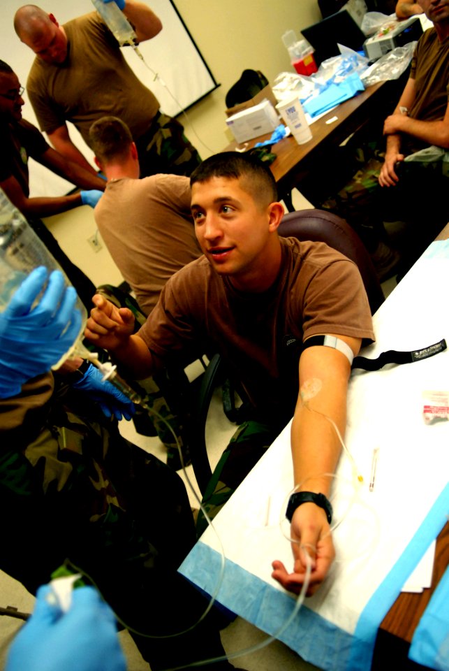 US Navy 081203-N-3674H-278 Ensign Christopher Waldrop receives saline solution via intravenous therapy