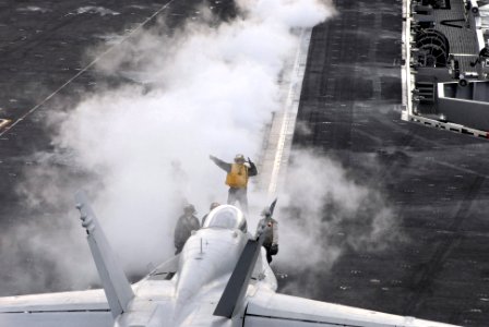 US Navy 081124-N-3610L-187 Aviation Boatswain's Mate (Handling) 2nd Class Diego Salvador directs an F-A-18C Hornet