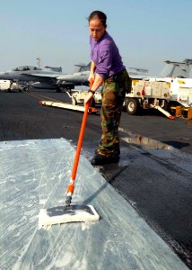 US Navy 081128-N-2456S-049 Aviation Boatswain's Mate (Fuels) Melanie Anaya, from Bronx, N.Y., cleans floor mats on the flight deck in preparation for the upcoming Maintenance Material Management (3M) inspection aboard the aircr