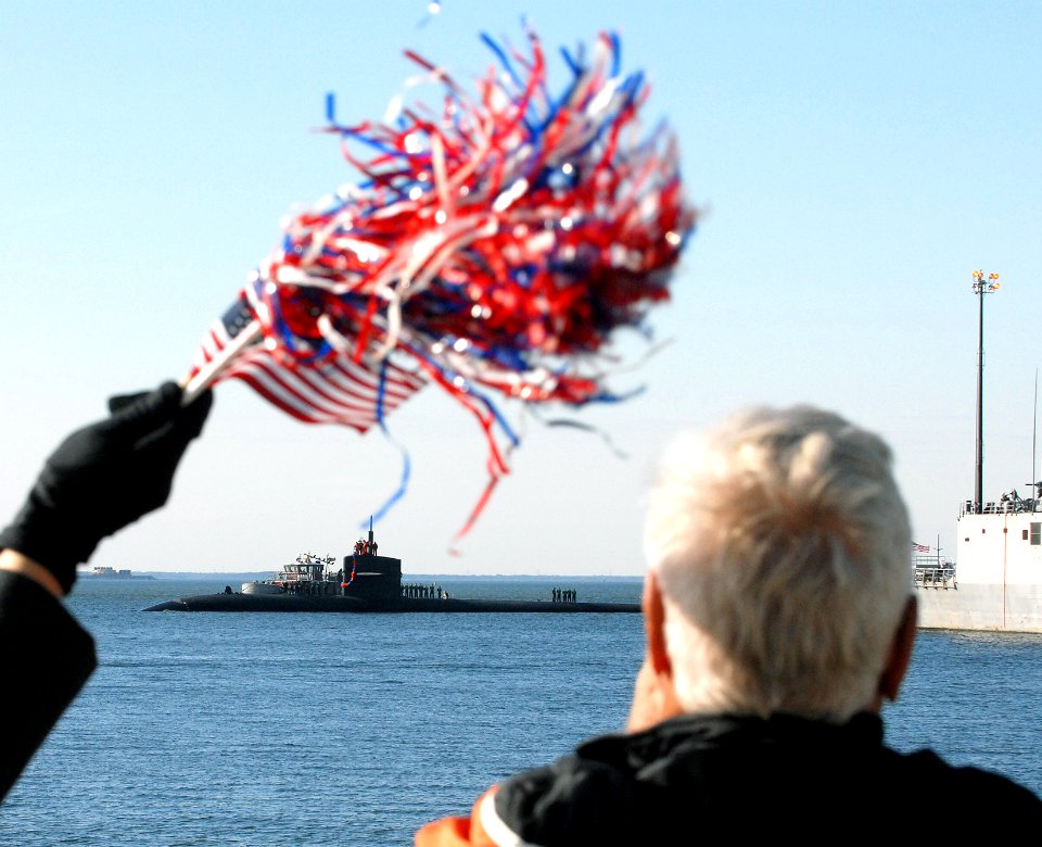 US Navy 081124-N-7668G-017 Family members of the crew of Los Angeles-class attack submarine USS Jacksonville (SSN 699) watch as the boat returns from a six-month deployment