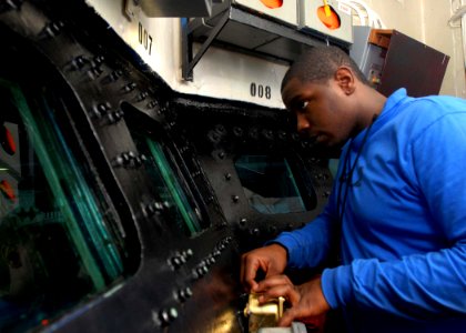 US Navy 081202-N-2456S-010 Aviation Boatswain's Mate (Handling) Airman Apprentice Sebrint Randolph stands watch in conflagration station two
