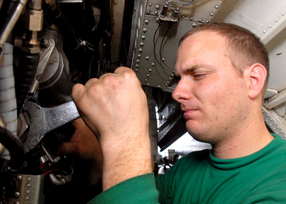 US Navy 081129-N-2456S-045 Aviation Machinist's Mate 2nd Class Ed Bryk, assigned to VAQ-141, installs a fuel temperature transmitter on an EA-6B Prowler in the hangar bay aboard the aircraft carrier USS Theodore Roosevelt (CVN