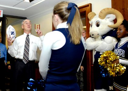 US Navy 081204-N-2855B-004 Deputy Secretary of Defense Gordon England welcomes the U.S. Naval Academy Band and cheerleaders during their annual pep rally through the halls of the Pentagon