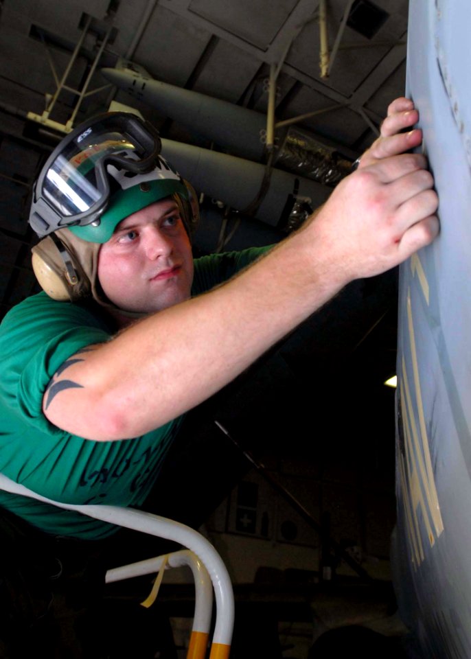 US Navy 081129-N-2456S-040 Aviation Structural Mechanic 3rd Class James Rhea, assigned to VAQ-141, tapes off the word