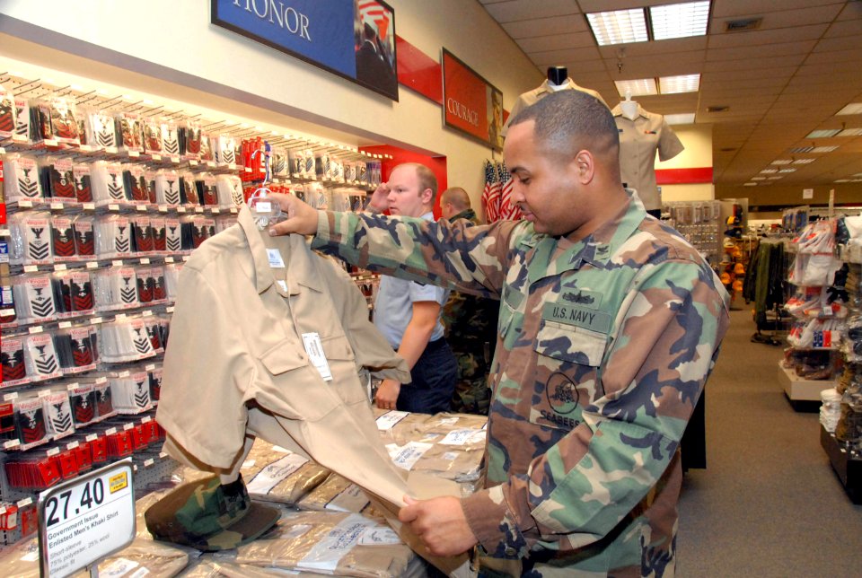US Navy 081201-N-2468S-003 Ship's Serviceman 2nd Class Charles Clay shops for the new service uniform at the Navy Exchange