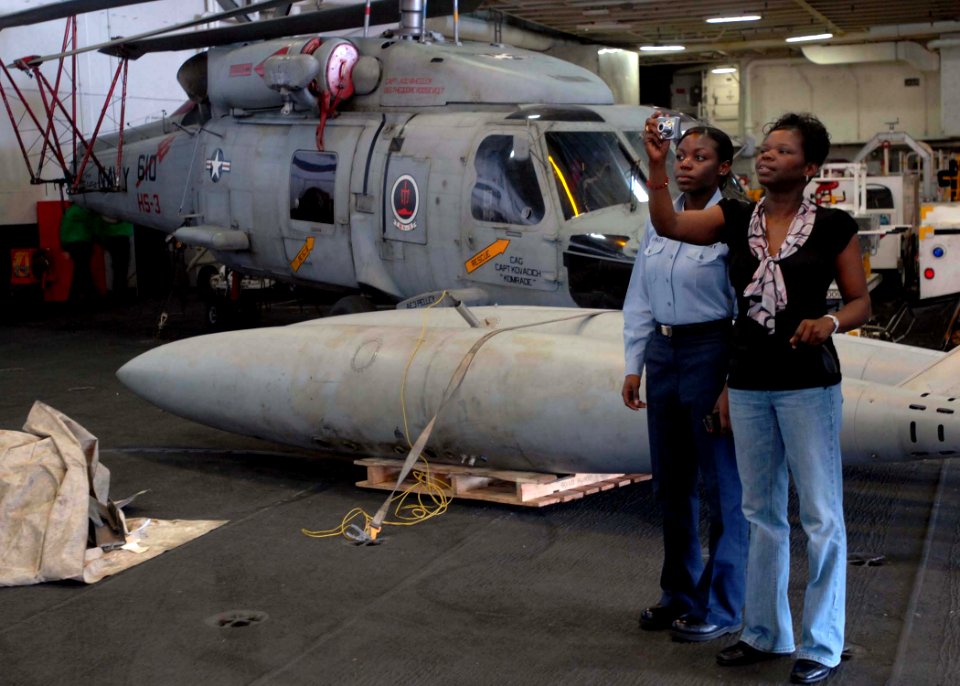 US Navy 081127-N-8822R-050 Jaqueline Easley takes a picture in the hangar bay with her daughter, Aviation Maintenance Administrationman 2nd Class Lavette Gonzalez