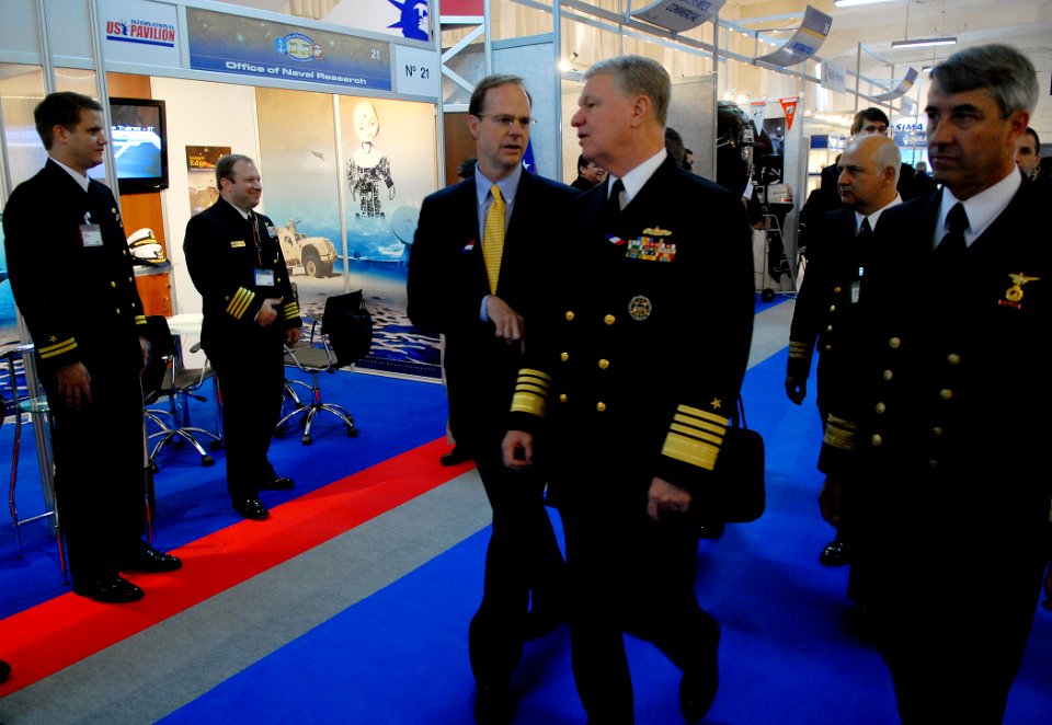 US Navy 081202-N-7676W-101 Chief of Naval Operations Adm. Gary Roughhead along with Paul Simons, pass the Office of Naval Research Global (ONRG) booth while visiting EXPONAVAL 2008