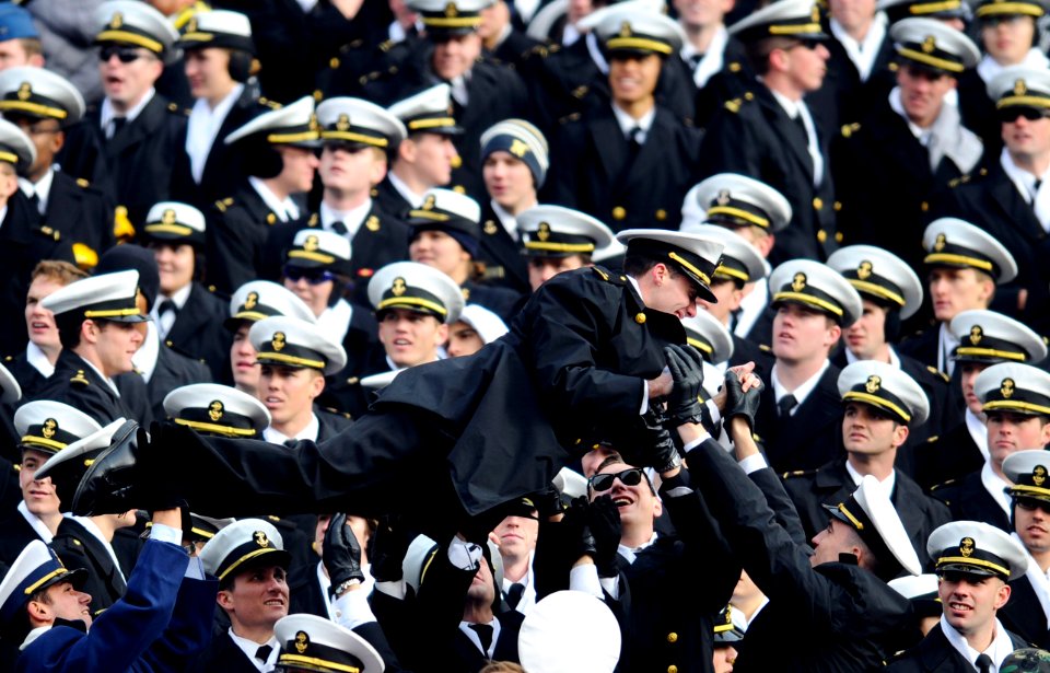 US Navy 081206-N-5345W-841 A U.S. Naval Academy midshipman is passed along by flellow midshipmen during the 109th Army-Navy college football game at Lincoln Financial Field in Philadelphia