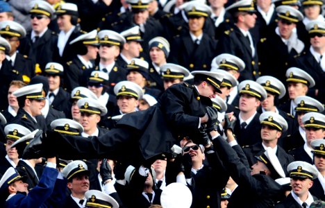 US Navy 081206-N-5345W-841 A U.S. Naval Academy midshipman is passed along by flellow midshipmen during the 109th Army-Navy college football game at Lincoln Financial Field in Philadelphia