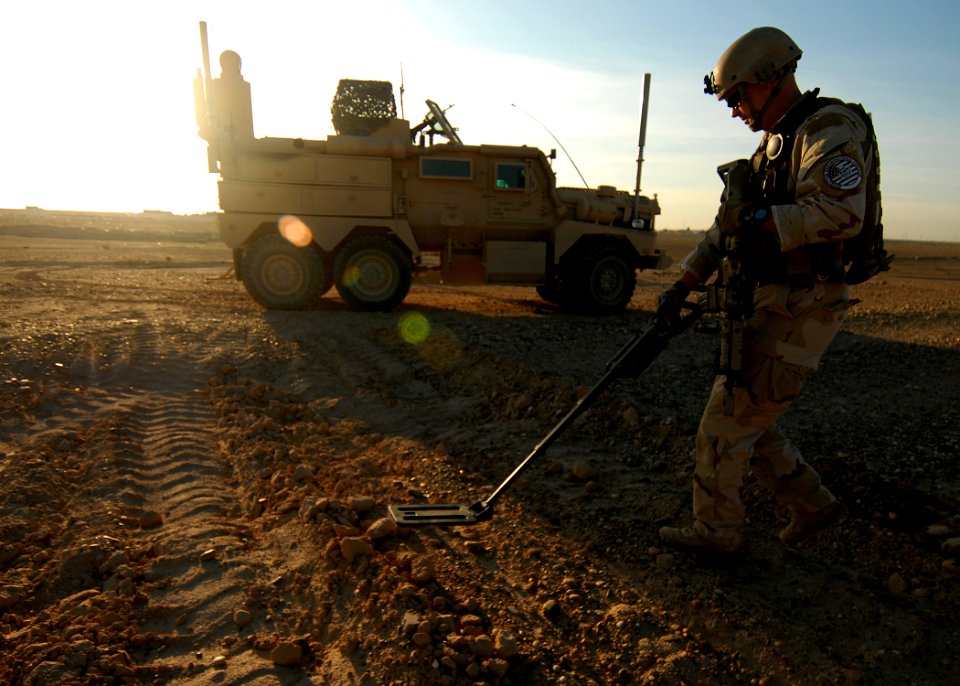 US Navy 081205-N-6278K-123 Explosive Ordnance Technician 1st Class Aaron Ritter, assigned to Explosive Ordnance Disposal Mobile Unit (EODMU) 1, uses a miniature mine detector to search for unexploded ordnance in Tikrit, Iraq