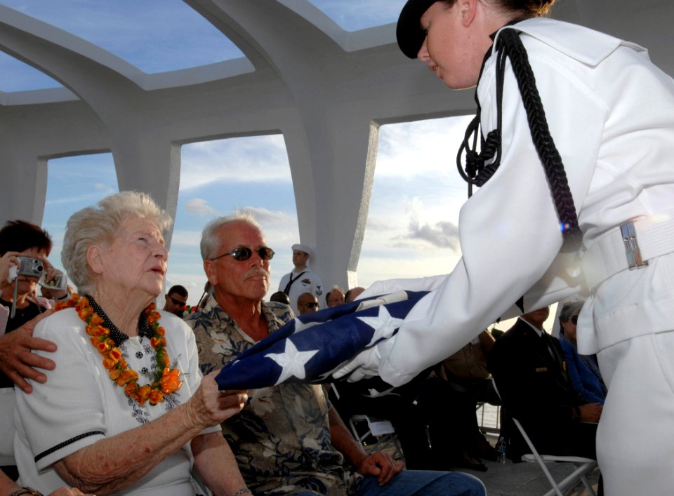 US Navy 081207-N-0535P-284 Margaret Guerin receives a folded American flag during her husband's interment ceremony