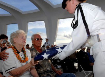 US Navy 081207-N-0535P-284 Margaret Guerin receives a folded American flag during her husband's interment ceremony