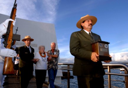 US Navy 081207-N-0535P-241 Daniel Martinez, historian for the National Park Service at the USS Arizona Memorial, walks with the cremains of Seaman 1st Class Charles Guerin Jr. during an interment ceremony at the USS Arizona Mem