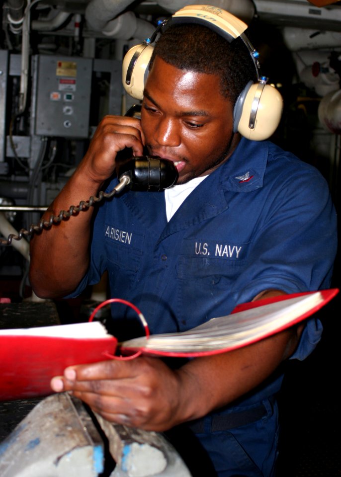 US Navy 081202-N-6764G-065 Engineman 3rd Class Paris Pharisien gives a status reports during a roving watch