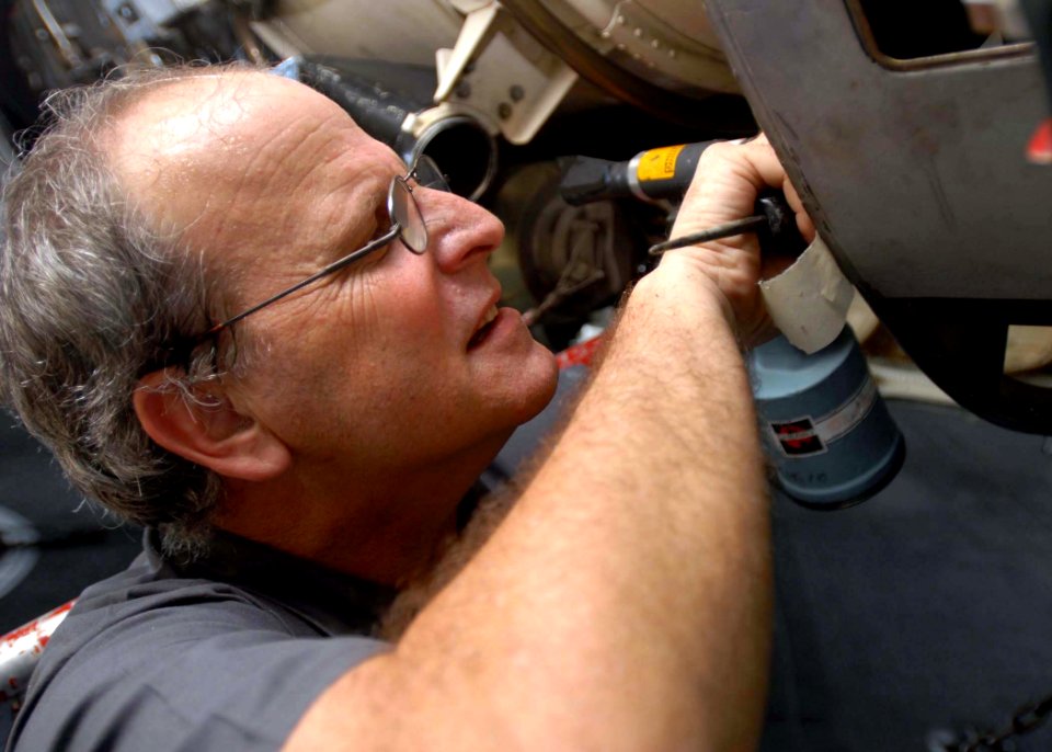 US Navy 081204-N-2456S-086 Mr. Timothy Kennedy installs a cherry max rivet on an EA-6B Prowler