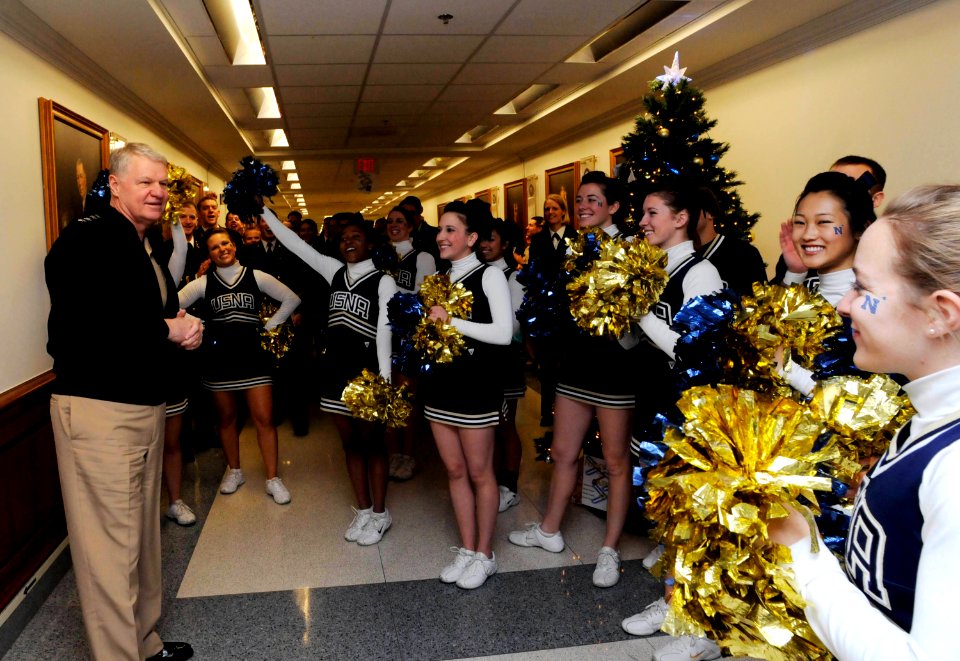 US Navy 081204-N-8273J-055 Chief of Naval Operations Adm. Gary Roughead cheers with the U.S. Naval Academy cheerleaders during a pep rally at the Pentagon