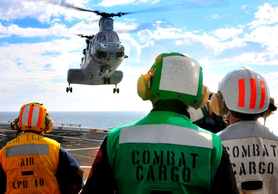 US Navy 081207-N-4774B-150 Aviation Boatswain's Mates (Fuel) handlers prepare for a helicopter landing