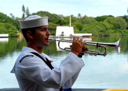 US Navy 081207-N-5476H-176 Musician 3rd Class Bryan Parmann plays Taps during the conclusion of a joint U.S. Navy-National Park Service ceremony commemorating the 67th anniversary of the attack on Pearl Harbor