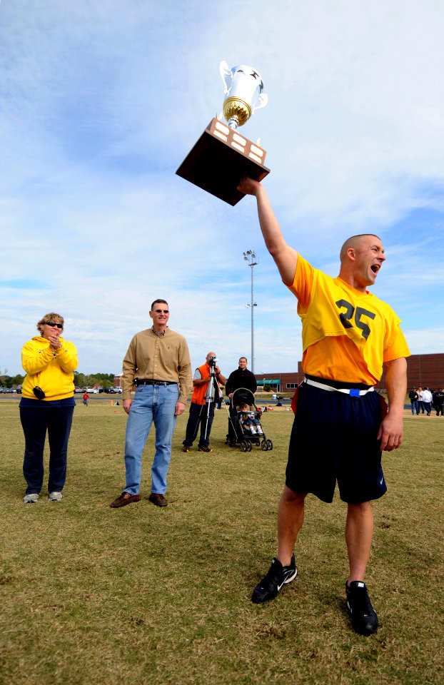 US Navy 081206-N-5328N-165 Navy flag football team captain Marine Corps Capt. Audie Cooper holds the Army-Navy trophy