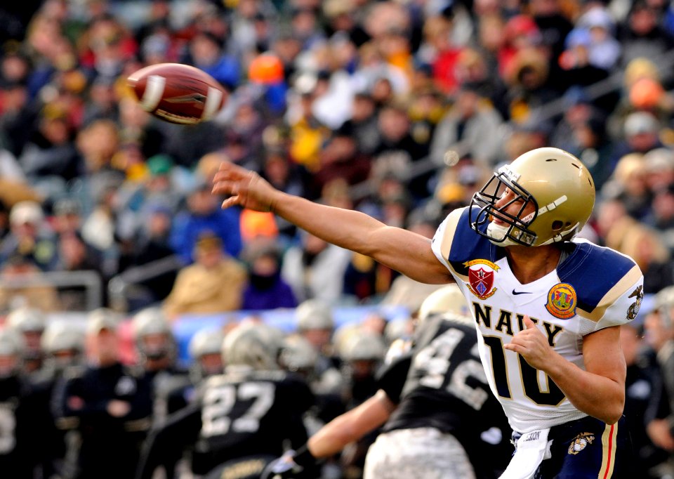 US Navy 081206-N-4565G-589 U.S. Naval Academy quarterback Kapo-Noa Kaheaku-Enhada (^10) throws a pass during the 109th Army-Navy college football game at Lincoln Financial Field in Philadelphia