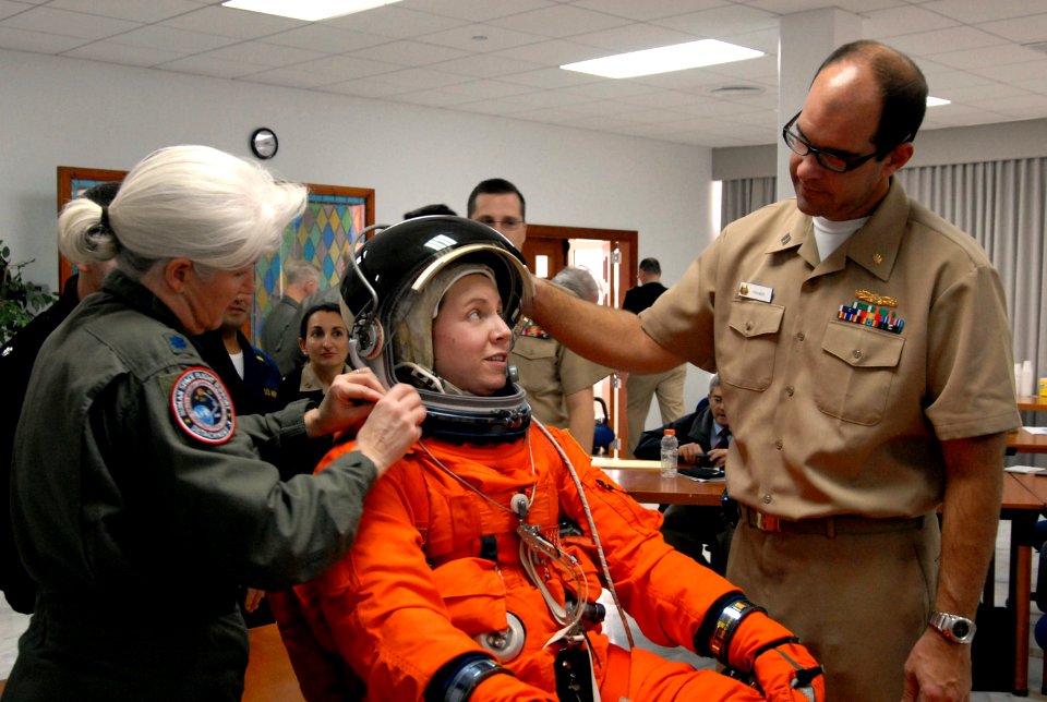 US Navy 081209-N-1825E-020 NASA training team member Lt. Col. Melinda Screws shows students how to adjust a space suit helmet a training class for the Space Shuttle Transoceanic Abort Landing Site Program
