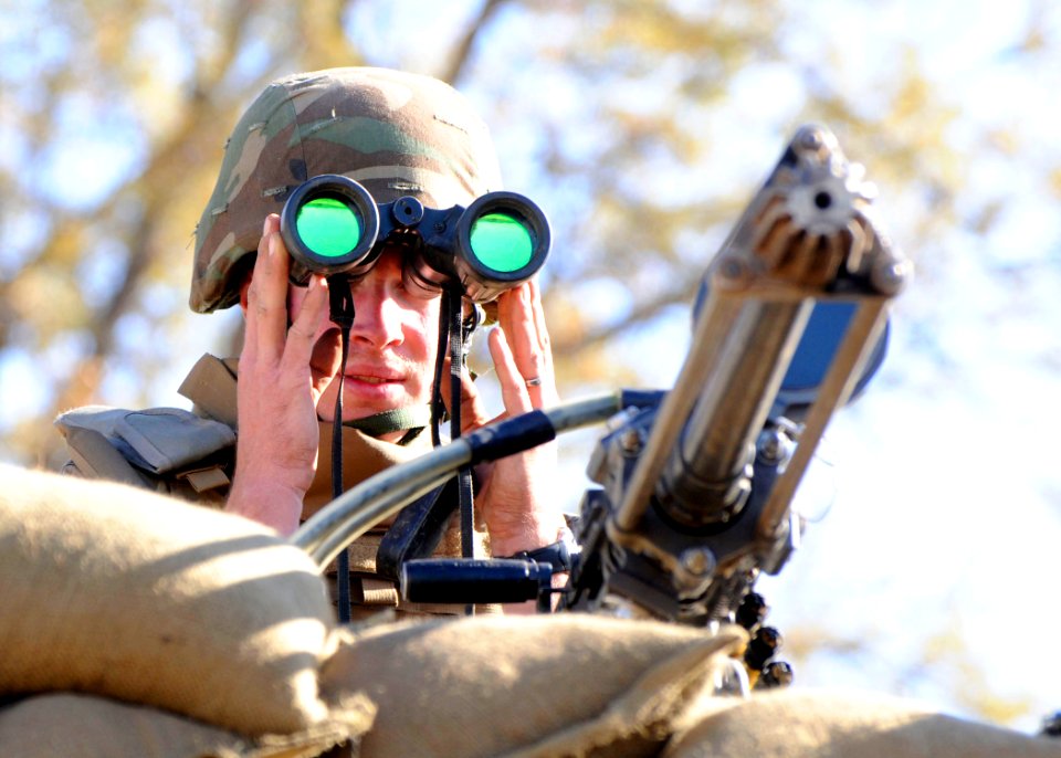US Navy 081209-N-9584N-062 teel Worker 3rd Class Dalton Kotz watches the perimeter from his perch next to a .50-caliber Browning machine gun