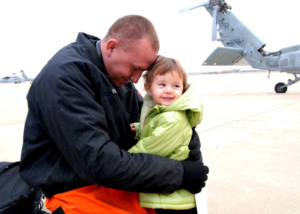 US Navy 081202-N-8933S-054 Aviation Structural Mechanic 2nd Class Richard Evans greets his daughter during a homecoming ceremony