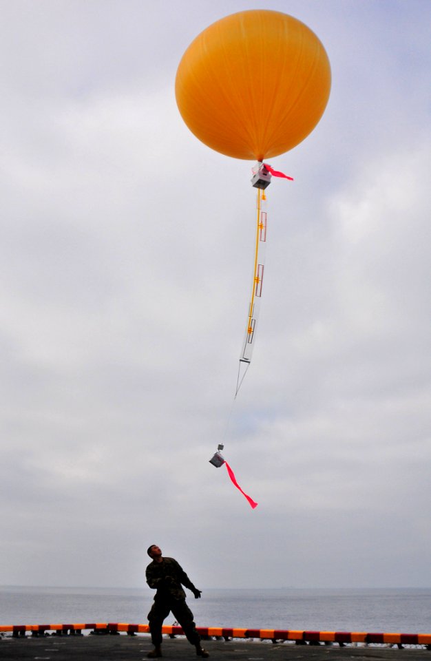 US Navy 081203-N-4774B-113 A Marine assigned to the 13th Marine Expeditionary Unit (13th MEU) releases a Combat Sky satellite communication balloon from the deck of the amphibious assault ship USS Boxer (LHD 4)