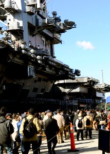 US Navy 081206-N-8534H-005 Visitors wait in line for a chance to tour the world's only permanently forward-deployed aircraft carrier, USS George Washington (CVN 73), during Fleet Activities Yokosuka's (CFAY) Grand Illumination