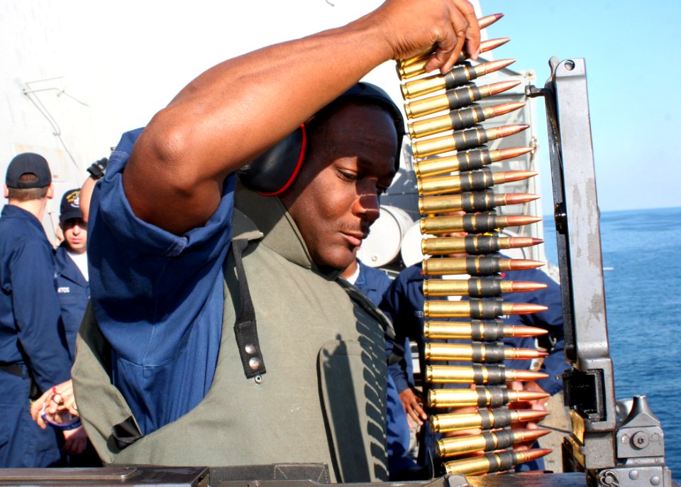 US Navy 081209-N-6764G-368 Yeoman 1st Class Richard Campbell loads a .50 caliber machine gun
